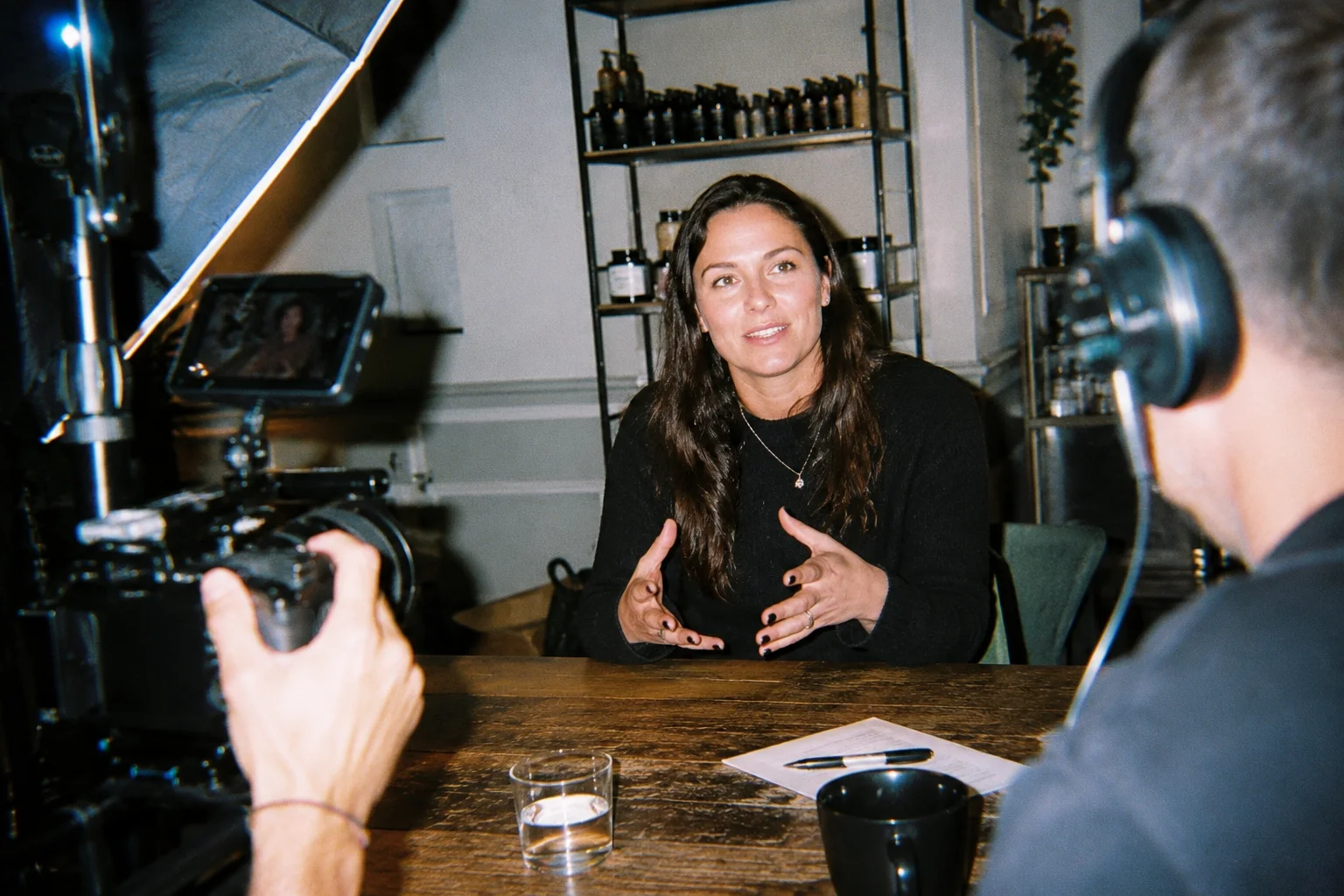 A customer being filmed for a video interview, camera and crew in frame